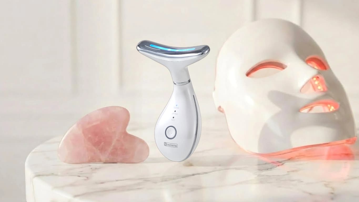 Viminto 3-in-1 Face Massager with LED light glowing on marble surface